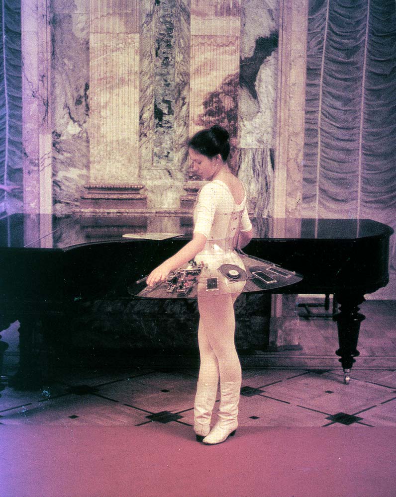 Ballerina sampling Lenin‘s piano. Marble Palace, St. Peterburg.1991.